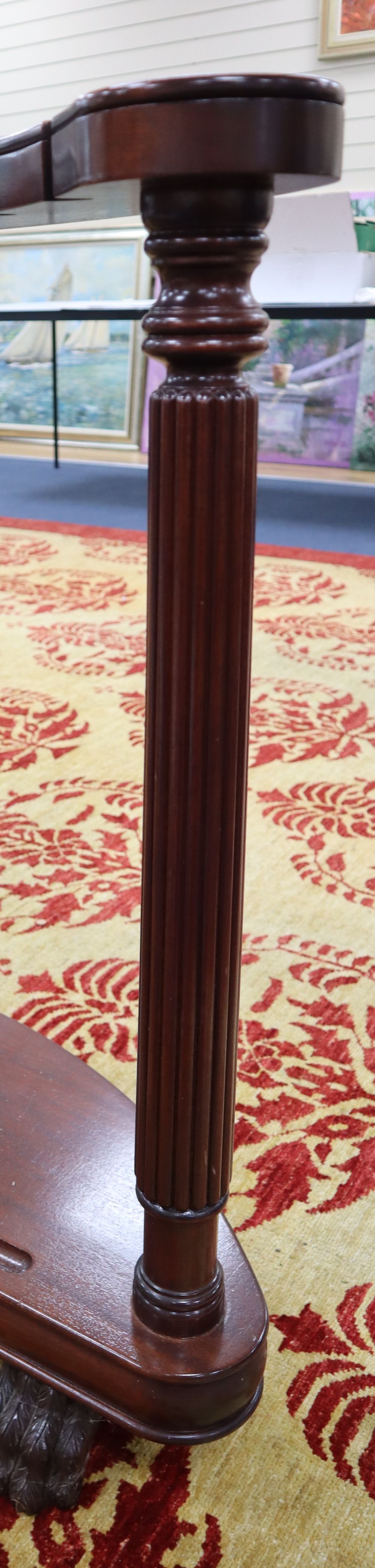 A mahogany sword stand, bow shape with reeded columns, claw feet, 92cm